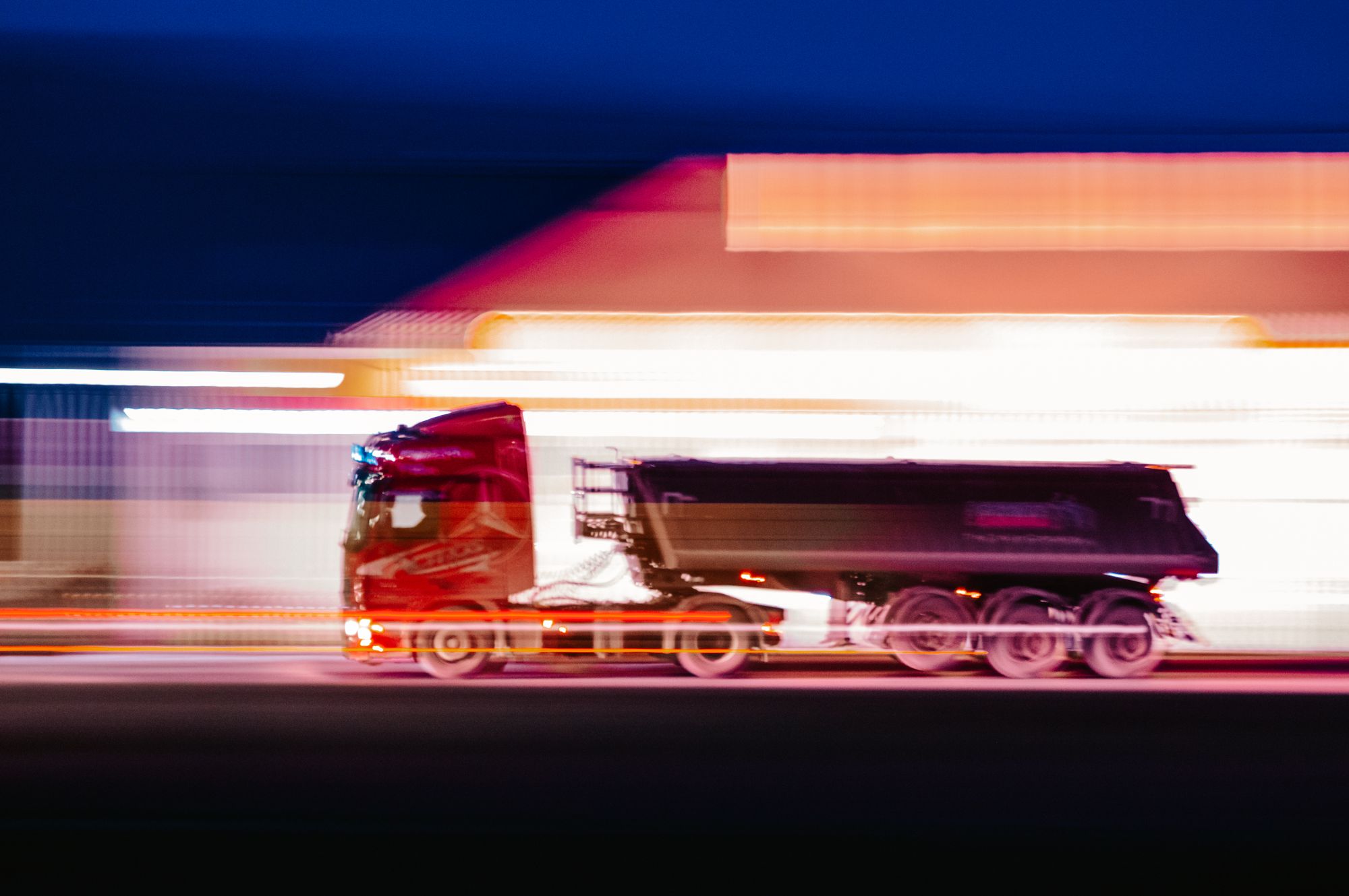 A transport truck at dusk on the open road